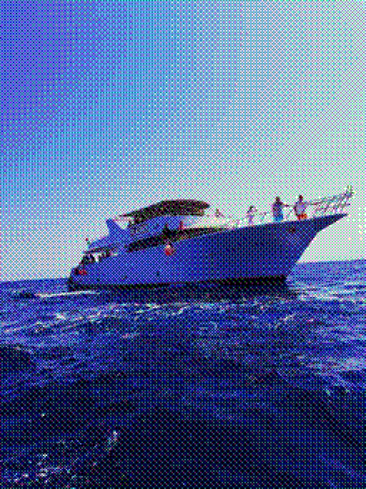 A white passenger boat on deep blue water