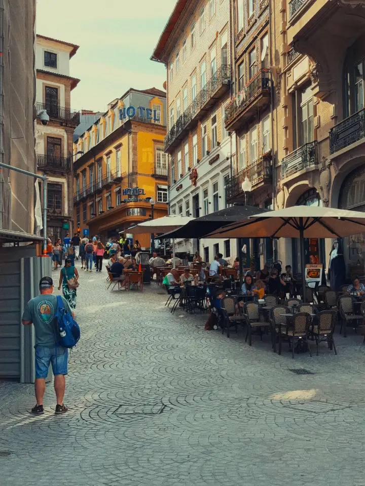 Market stalls along a narrow street lined with old buildings